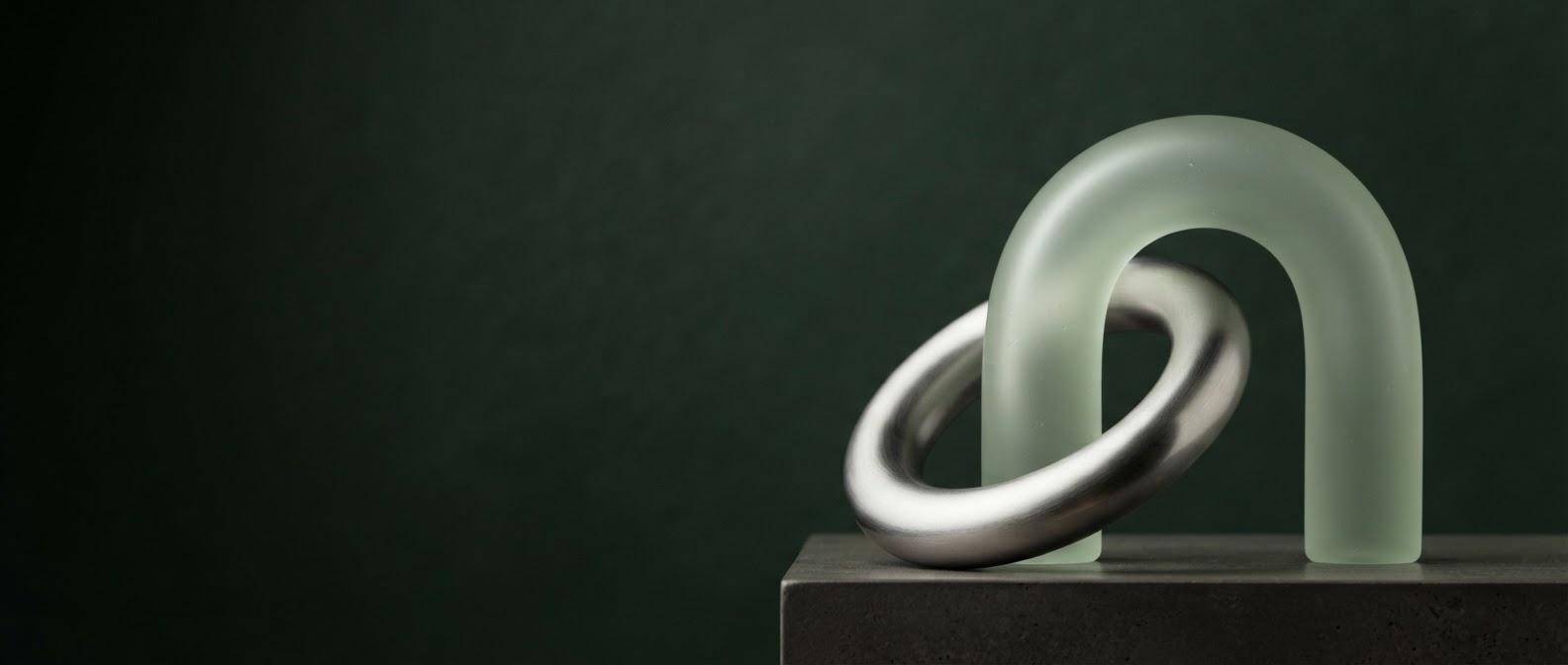 Sculptural interlocking forms against a green background