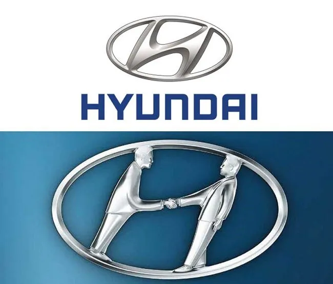 Hyundai emblem shown with two people shaking hands inside the oval