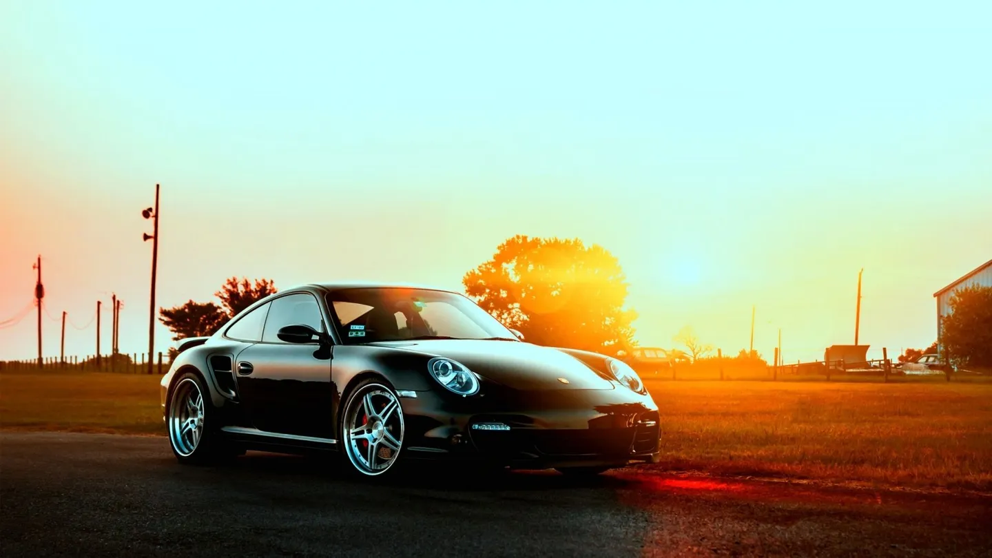 A Porsche sports car at sunset