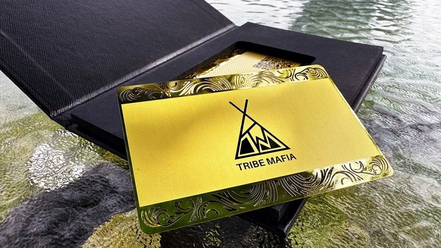 A gold-coloured metal business card presented in a black box