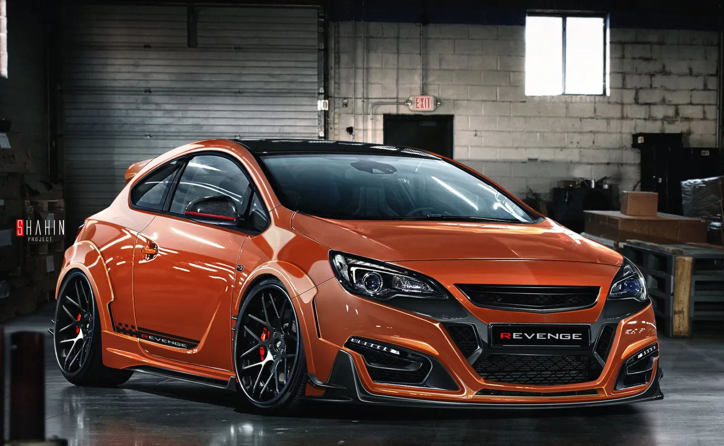 An orange modified Vauxhall saloon in a workshop