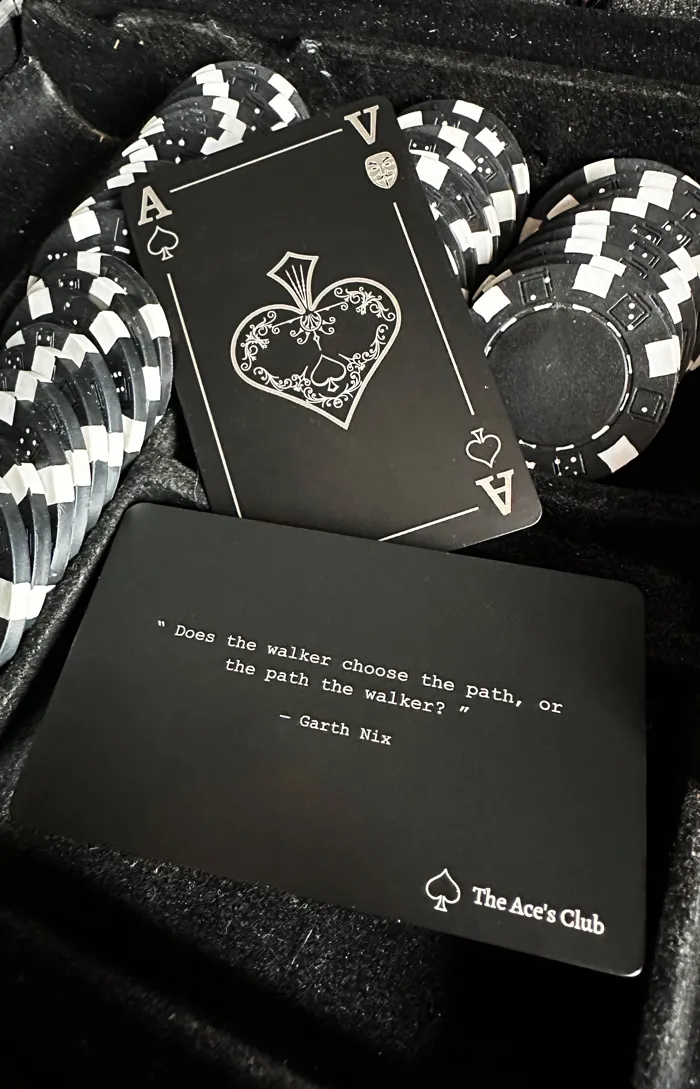 A black metal card with a diamond illustration and its presentation box