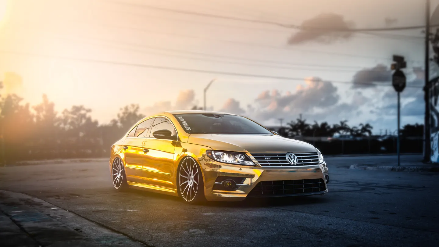 A gold Volkswagen Passat at sunset
