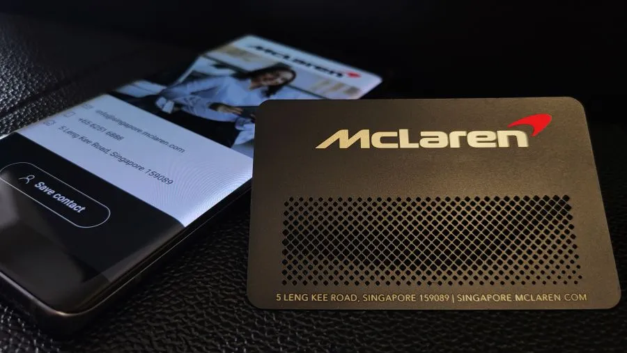 A McLaren-branded metal card beside a phone