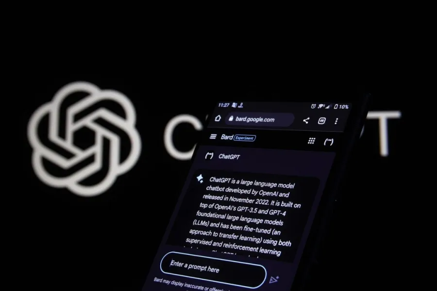 ChatGPT on a phone beside the OpenAI symbol