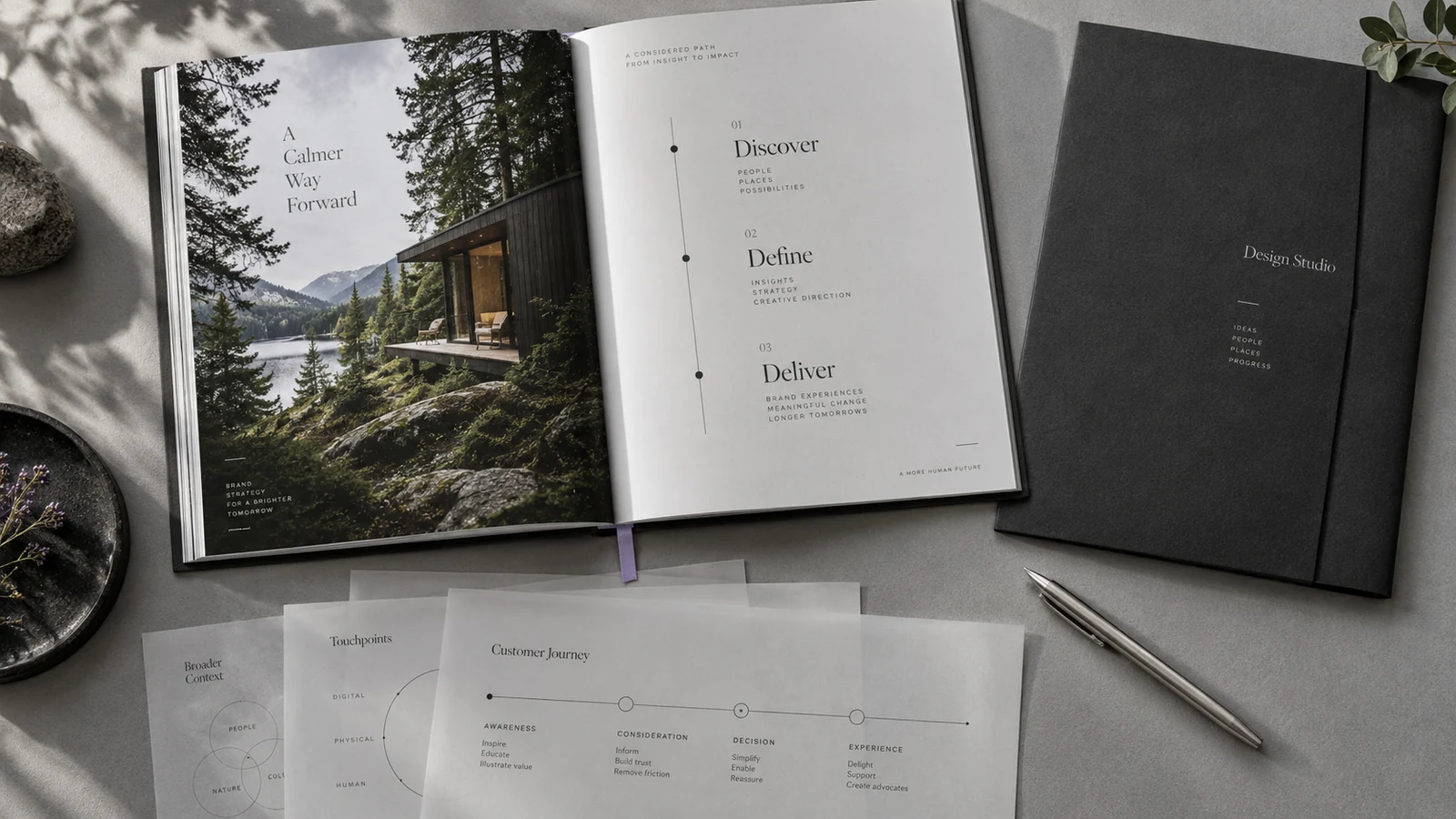 A printed strategy book, customer journey diagrams and a Design Studio brief